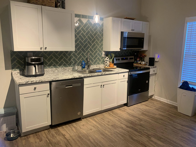 a kitchen counter with a complete mosaic tile backsplash installed