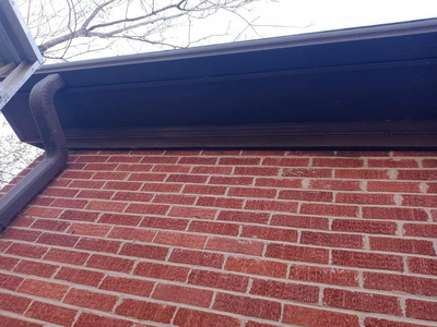 A repaired gutter and re-lined roof overhang