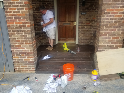Entryway steps clad in dark brown wood