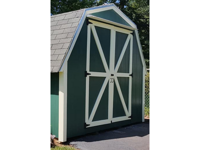 A freshly painted shed with new door and trim